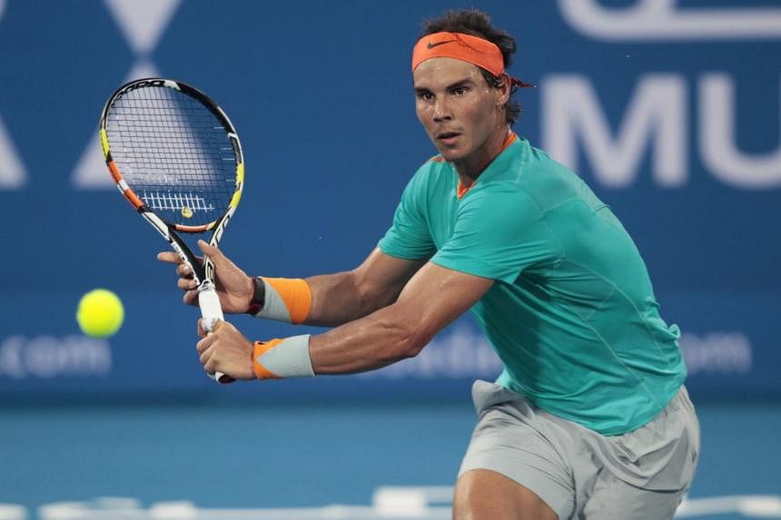 Rafael Nadal of Spain (above) returns the ball to Andy Murray of Britain during their semi-final match at the Mubadala World Tennis Championship in Abu Dhabi on Jan 2, 2015. -- PHOTO: REUTERS