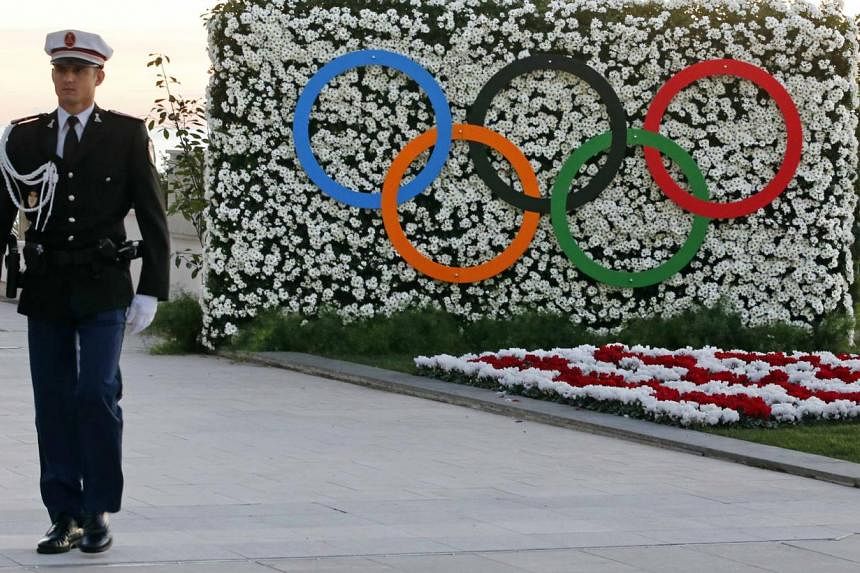 A Monaco's policeman walks past the Olympic rings during the opening of the 127th International Olympic Committee (IOC) session in Monaco on Dec 8, 2014. -- PHOTO: REUTERS