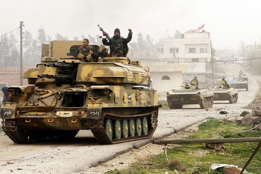 Syrian soldiers on army tanks are seen at Deir al-Adas town in the southern province of Daraa, Syria,on Feb 11, 2015. -- PHOTO: EPA