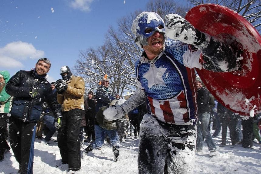 Mr Collin Lawrence, dressed up as comic superhero Captain America, joins other Washington DC residents in a massive snowball fight. -- PHOTO: REUTERS