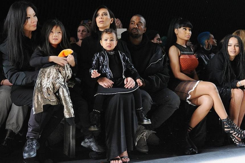 (From left) Aimie Wang, Alia Wang, Kim Kardashian, North West, Kanye West, Nicki Minaj and Zoe Kravitz attend the Alexander Wang Fashion Show during the Mercedes-Benz Fashion Week Fall 2015 at Pier 94 in New York City on Feb 14, 2015. -- PHOTO: AFP