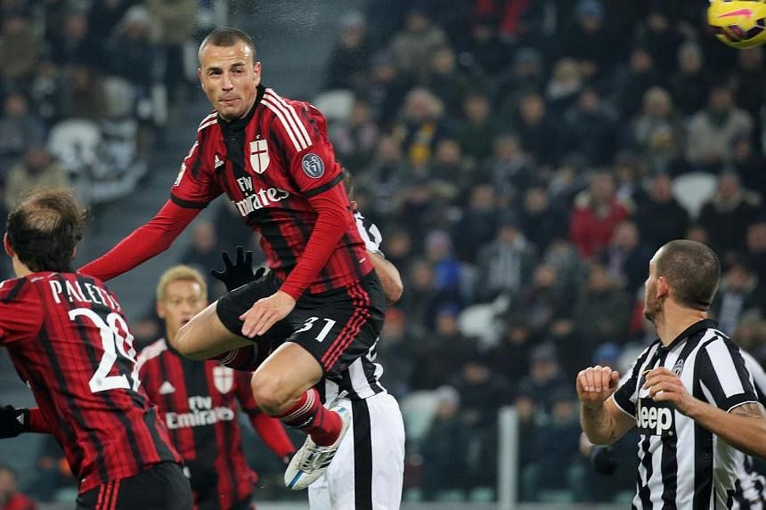 AC Milan in action against Juventus at the Juventus Stadium in Turin on Feb 7, 2015. AC Milan owner Silvio Berlusconi has rejected an offer of €970 million (S$1.5 billion) for the embattled Serie A club but could sell a minority stake if it came wi