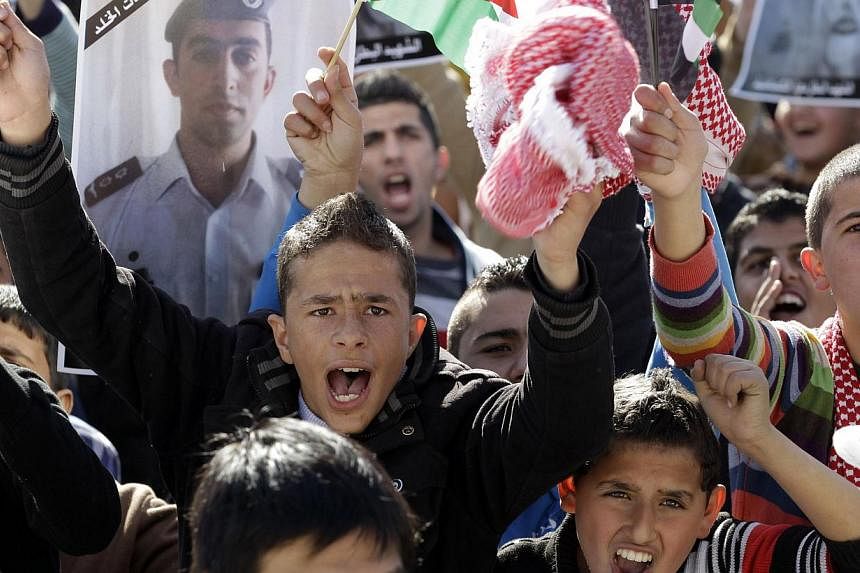 Young Jordanians shouting slogans on Feb 5, 2015 in Amman during a rally against the Islamic state group and in reaction to the burning of Jordanian pilot Maaz al-Kassasbeh by the group's militants. -- PHOTO: AFP&nbsp;