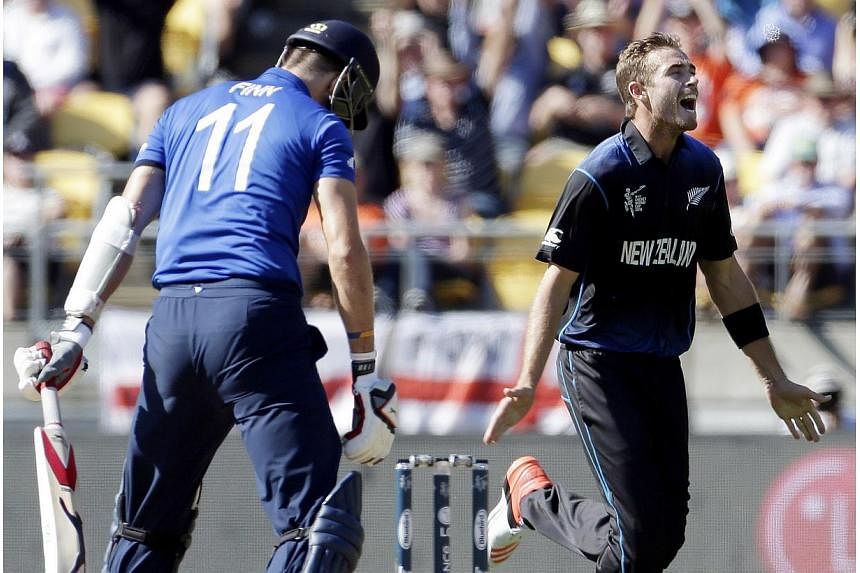 New Zealand's Tim Southee (right) celebrates dismissing England's Steven Finn (left) for a duck during their Cricket World Cup match at Wellington Stadium in Wellington on Feb 20, 2015. -- PHOTO: REUTERS