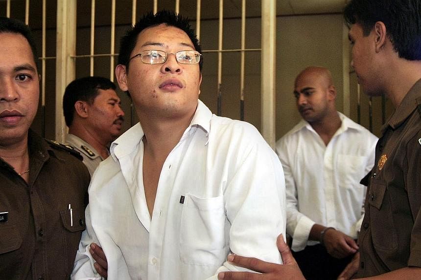 In this file photograph taken on Feb 14, 2006, Australian drug smugglers Andrew Chan (centre) followed by Myuran Sukumaran (right in white shirt), are escorted by prison guards following a court hearing in Denpasar, on Bali island. The execution of t