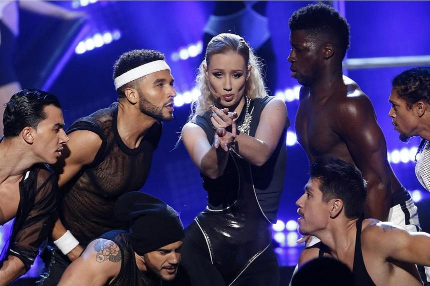 Iggy Azalea (centre) performs Beg For It during the 42nd American Music Awards in Los Angeles, California on Nov 23, 2014. -- PHOTO: REUTERS