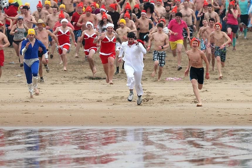 Participants run towards the waters of the North Sea during the annual New Year swim in Ostend, Belgium on Jan 3, 2015. The month of January was the second warmest on record, according to an analysis of global averages for temperature over land and s