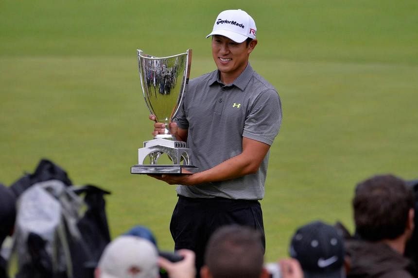 James Hahn holds the trophy on the 18th hole after putting in for the win on the 14th hole amid the Final Round of the Northern Trust Open at the Riviera Country Club on Feb 22, 2015 in Pacific Palisades, California. -- PHOTO: AFP