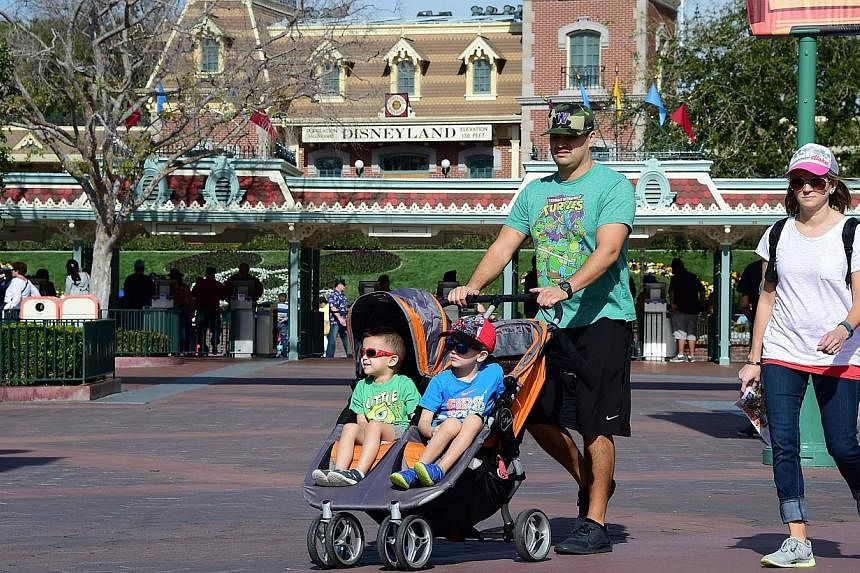 A family visitng Disneyland on Jan 22, 2015, in Anaheim, California. -- PHOTO: AFP