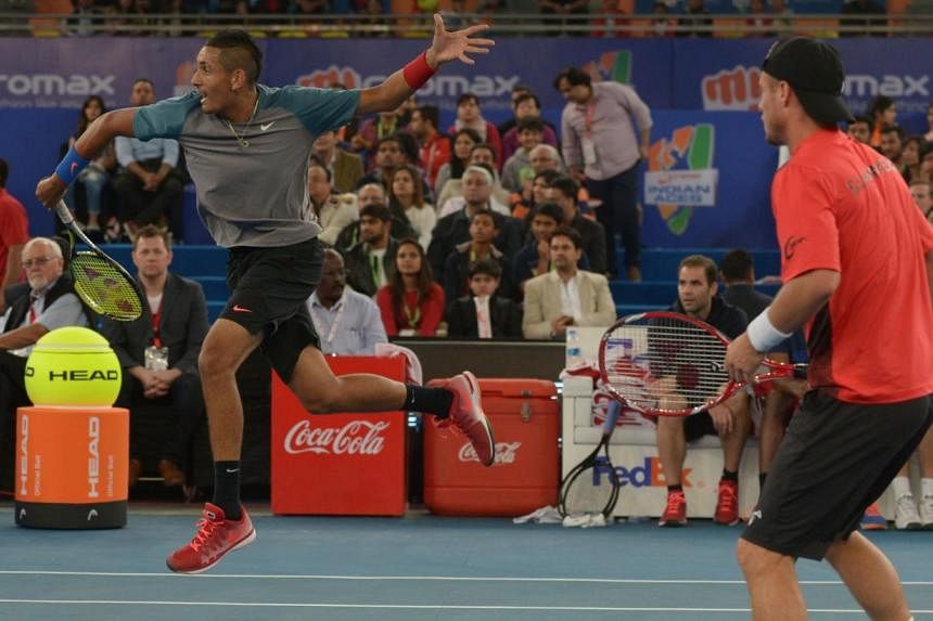 Australia's Nick Kyrgios (left) and Lleyton Hewitt of the Singapore Slammers play a shot against Indian Aces tennis player Rohan Bopanna and Switzerland's Roger Federer during their International Premier Tennis League (IPTL) nen's doubles match in Ne