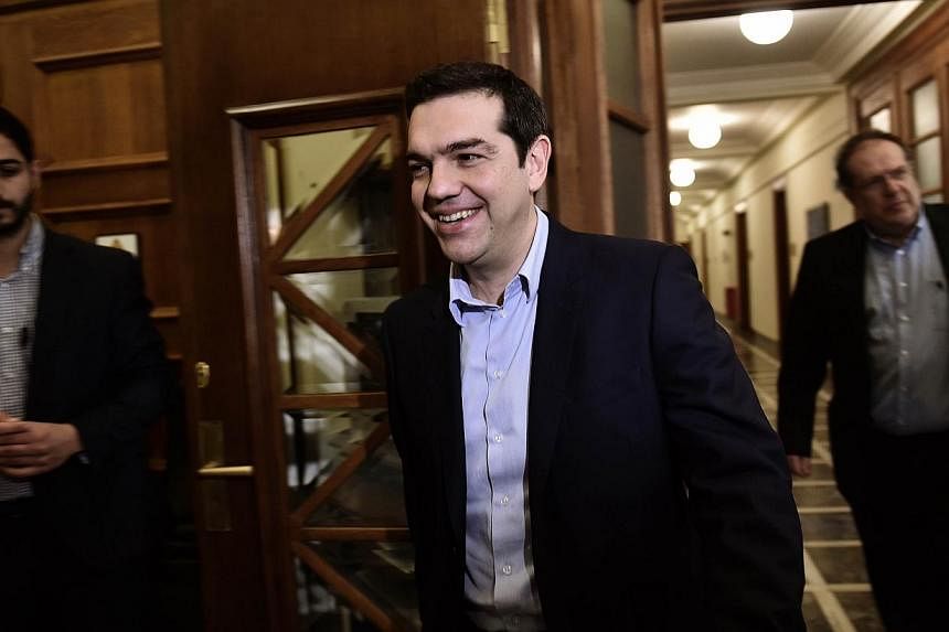 Greek Prime Minister Alexis Tsipras arrives for a ministerial meeting at the parliament in Athens on Feb 24, 2015.&nbsp;-- PHOTO: AFP