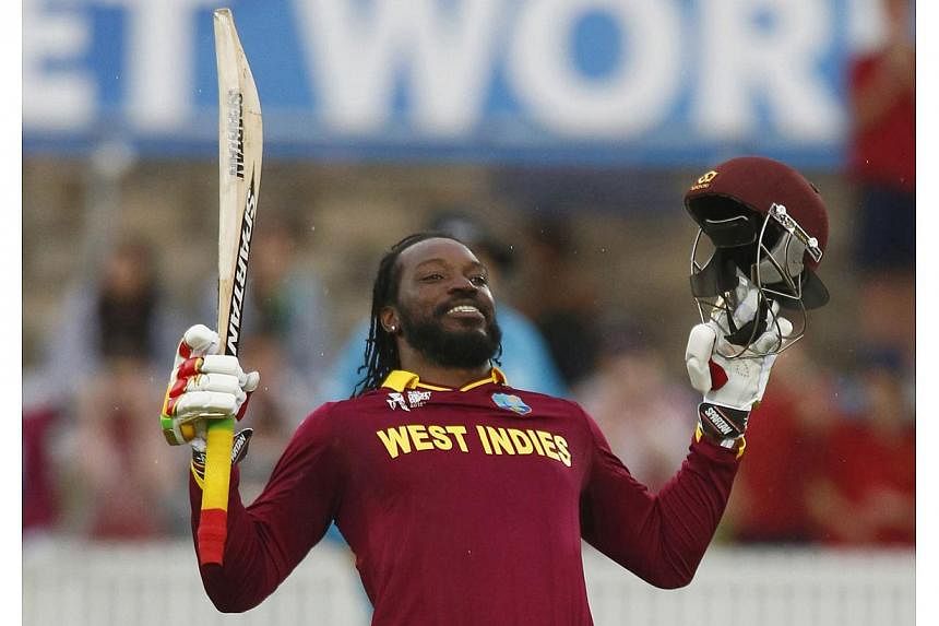 West Indies batsman Chris Gayle celebrates scoring 200 runs, a double century, during their World Cup Cricket match against Zimbabwe in Canberra on Feb 24, 2015.&nbsp;Gayle smashed the highest-ever individual World Cup score with his 215 to power the