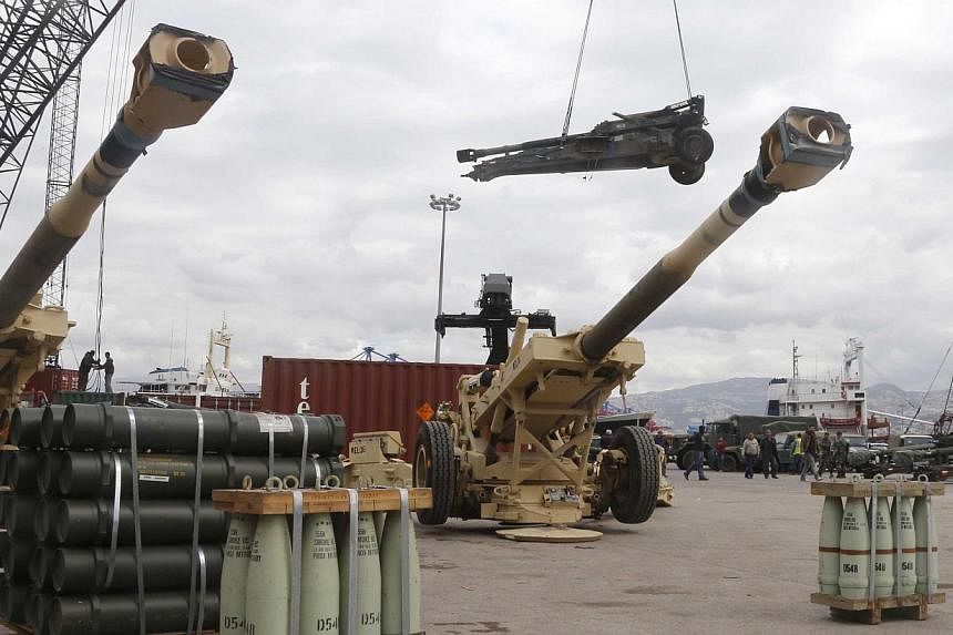 Workers unload artillery pieces donated from the US government to the Lebanese army, during a ceremony at Beirut's port on Feb 8, 2015. Fellow Middle Eastern nation Jordan has also delivered heavy military equipment to Lebanon to bolster their fight 