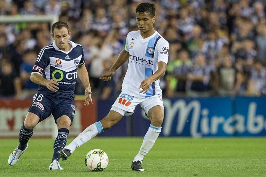 Melbourne City's Singaporean defender Safuwan Baharudin (in white) controls the ball against Melbourne Victory's Leigh Broxham, during his debut in the Australian League at the Etihad Stadium in Melbourne, Australia, on Feb 7, 2015. -- PHOTO:&nbsp;ME