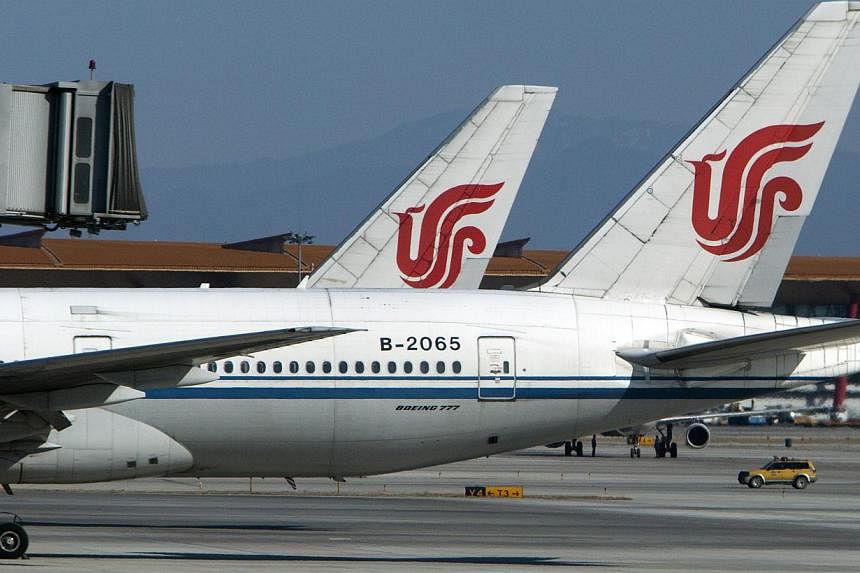 Air China planes parked at Beijing International Airport. Boarding for one of the airline's flights from Seoul to Chongqing on Feb 21, 2015, was reportedly delayed due to a late flight attendant who went shopping. -- PHOTO: BLOOMBERG &nbsp;
