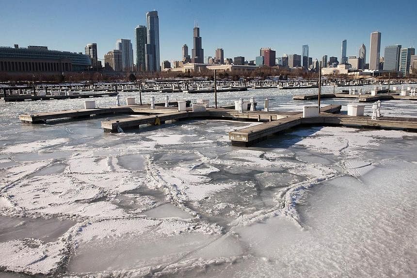 Ice surrounding a boat dock in a harbour along Lake Michigan on Feb 23, 2015, in Chicago, Illinois. -- PHOTO: AFP