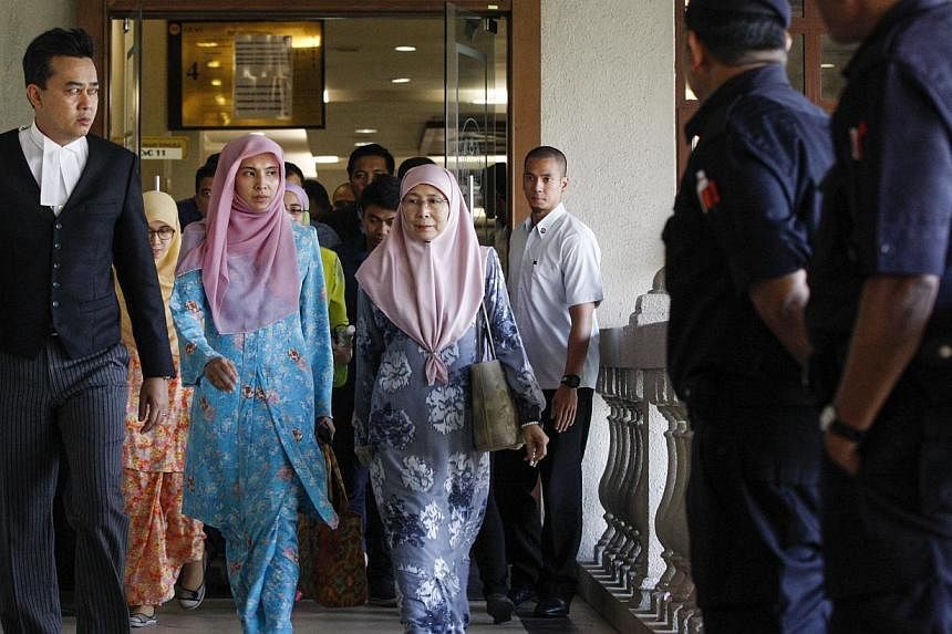 Madam Wan Azizah (centre), wife of Malaysian opposition leader Anwar Ibrahim, attending her husband's court case against Foreign Affairs Minister Anifah Aman in the Duta Court Complex at Kuala Lumpur, Malaysia on Feb 17, 2015. -- PHOTO: EPA&nbsp;