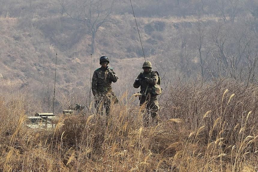 South Korean soldiers standing on the top of a hill during a live-fire drill in Yangpyeong, 60km east of Seoul, on Feb 11, 2015. -- PHOTO: AFP&nbsp;
