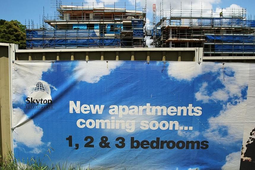 An advertisement for a residential project is displayed at a construction site in Sydney on Jan 24, 2015. Australia plans to charge fees to foreigners buying residential property in an attempt to improve housing affordability. -- PHOTO: BLOOMBERG