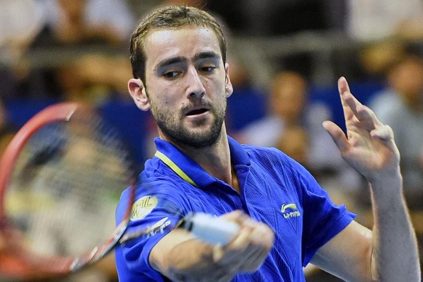 Croatia's Marin Cilic of the United Arab Emirates Royals plays against France's Jo-Wilfreid Tsonga of the Manila Mavericks during their men's singles at the International Premier Tennis League (IPTL) competition in Singapore on Dec 3, 2014. -- PHOTO:
