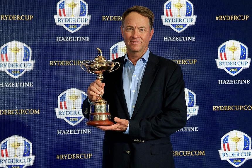 Davis Love III holds the Ryder Cup Trophy as he poses for the media during his announcement as the 2016 United States Ryder Cup Team Captain at the PGA headquarters on Feb 24, 2015 in Palm Beach Gardens, Florida. -- PHOTO: AFP