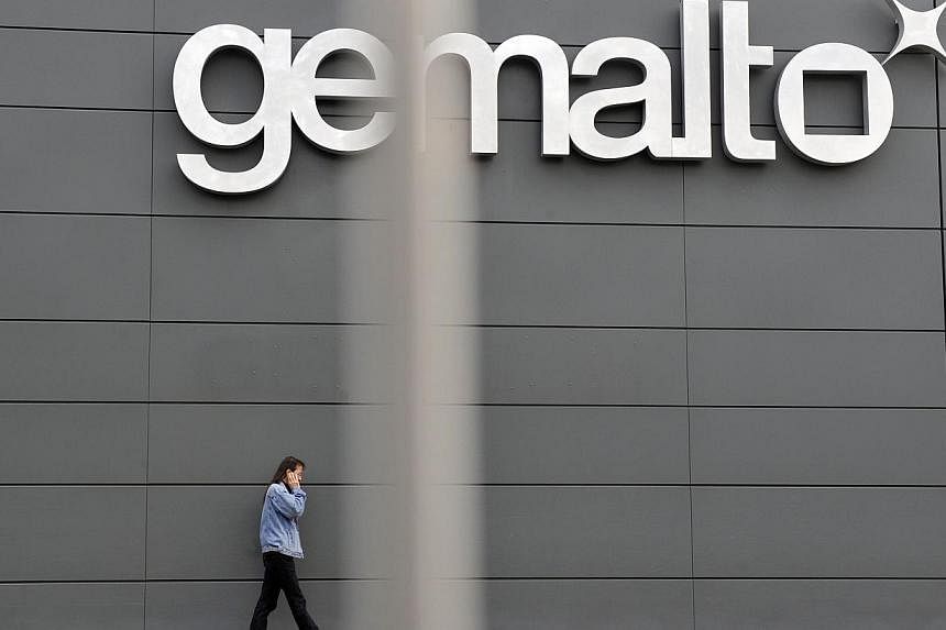 A file picture taken on November 10, 2009 shows an employee walking outside the Gemalto building, the world's leading digital security firm, in Gemenos, southern France.&nbsp;Gemalto NV, the maker of mobile-phone card software, said Wednesday it dete