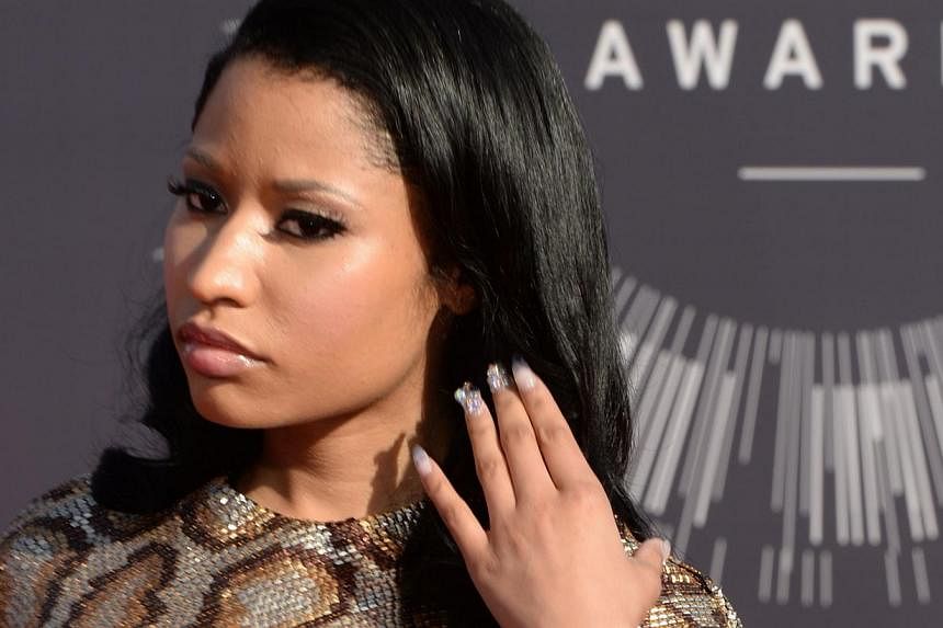 Nicki Minaj arriving at the MTV Video Music Awards in California on Aug 24, 2014. The Philadelphia police have charged a suspect with the stabbing of a member of the rapper's touring crew outside a local bar on Feb 18, 2015. -- PHOTO: AFP