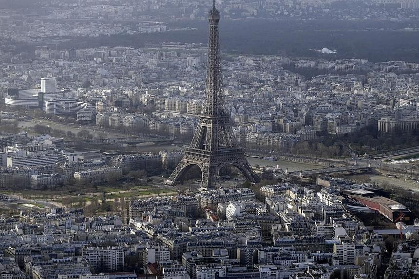 An aerial file photo taken on Jan 11 shows the Eiffel Tower in Paris. At least five drones were spotted flying over central Paris landmarks during the night and police were unable to catch the operators, sources close to the probe said on Tuesday. --