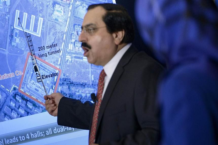Alireza Jafarzadeh of the National Council of Resistance shows satellite photos during a press conference at the National Press Club on Tuesday in Washington, DC. -- PHOTO: AFP