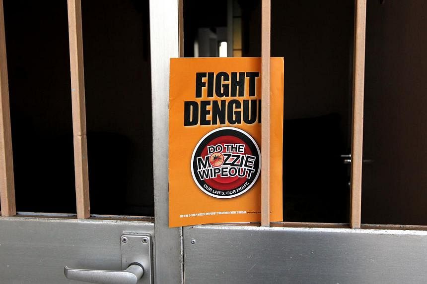 A dengue prevention pamphlet from the National Environment Agency (NEA) left on the gate of a HDB flat in 2013. -- PHOTO: ST FILE