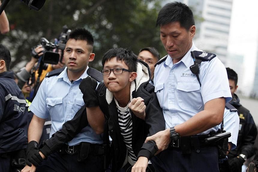 Hong Kong police detain a pro-democracy demonstrator (centre) as police clear the main protest site in the Admiralty district in Hong Kong on Dec 11, 2014. Asia's richest man, Li Ka Shing, said on Thursday, Feb 26, 2015,&nbsp;Hong Kong people would b