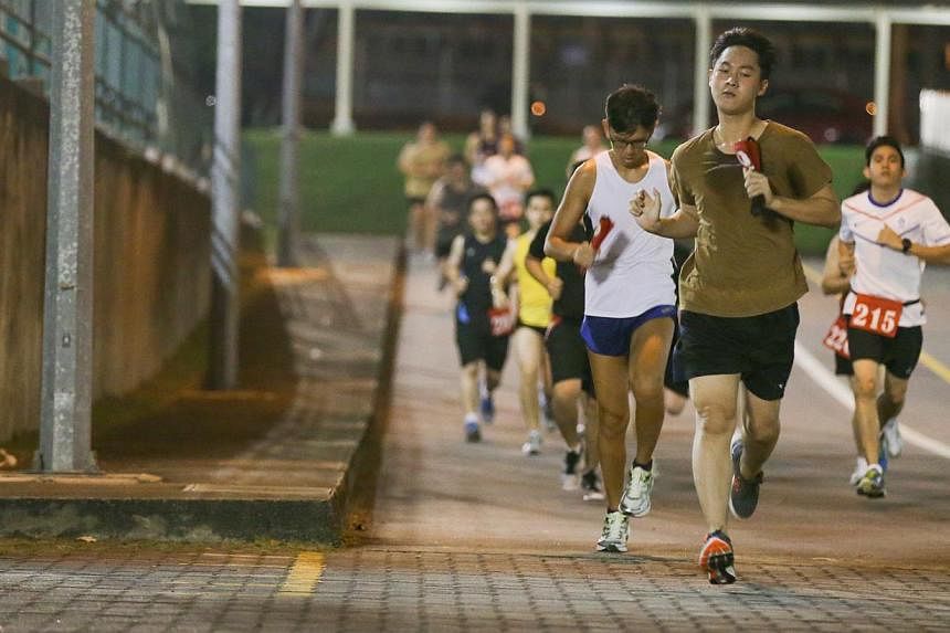 Operationally ready national servicemen (NSmen) running as part of IPPT Preparatory Training (IPT) programme in Maju Camp on Sept 8, 2014. -- ST PHOTO: ONG WEE JIN