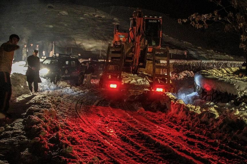 Afghan authorities remove snow from the roads as part of rescue efforts after an avalanche in the Panjshir valley, Afghanistan on&nbsp;Feb 25,&nbsp;2015. More than 200 people have been killed in the series of avalanches triggered by heavy snowfall, o