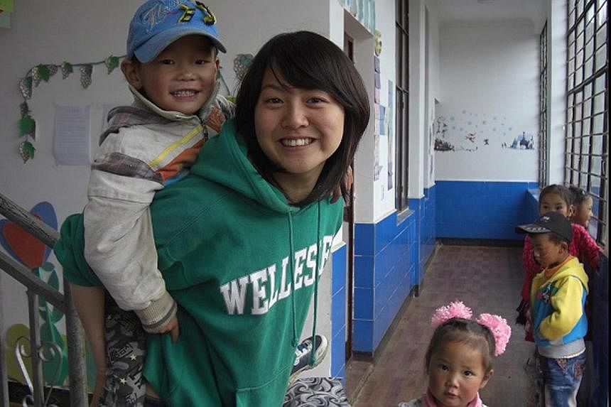 Miss Davina Huang with children at a kindergarten in Yunnan, China, during a teaching stint in 2011. The school will be one of the beneficiaries of funds originally raised to help her family with the medical costs.
