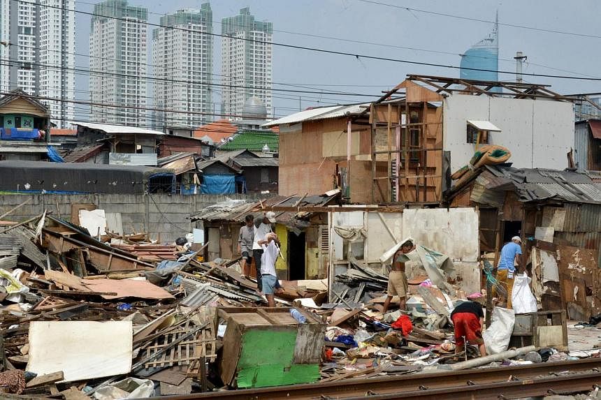 Slum dwellers dismantling their shanty houses along railroad tracks in Jakarta last August. Indonesia's government has failed in multiple attempts to provide housing for its vast low-income population.