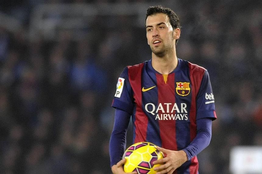 Barcelona's midfielder Sergio Busquets stands with the ball during the Spanish league football match Real Sociedad de Futbol vs FC Barcelona in San Sebastian on Jan 4, 2015. Busquets has extended his contract with the Catalan giants until 2019, the c