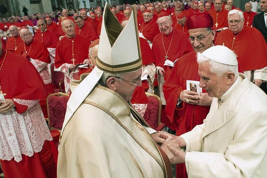 Pope Francis (left) greeting Emeritus Pope Benedict XVI at the Vatican on Feb 14, 2015. -- PHOTO: REUTERS
