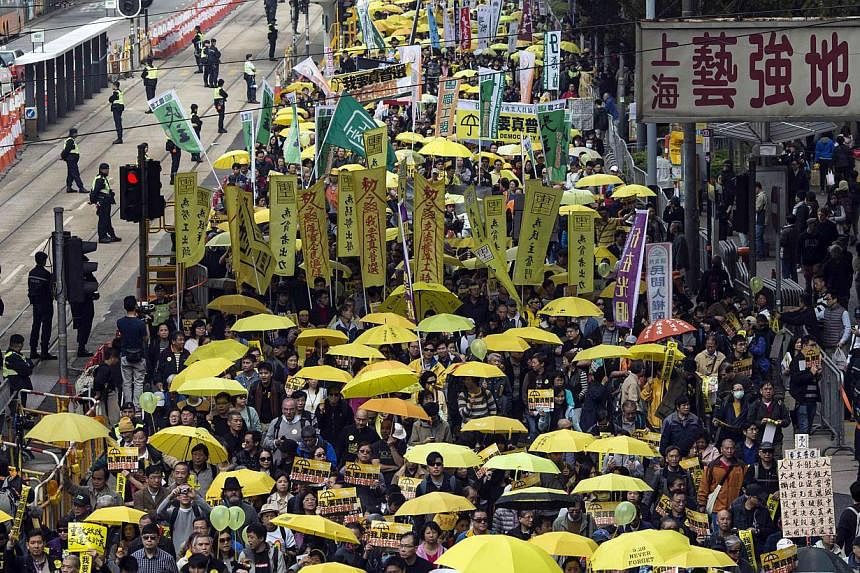 Thousands of pro-democracy protesters hold up yellow umbrellas, symbols of the Occupy Central movement, during a march in the streets to demand universal suffrage in Hong Kong on&nbsp;Feb 1, 2015. Britain's foreign secretary on Thursday, Feb 26, 2015