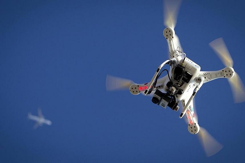 Three Al-Jazeera TV journalists were arrested in Paris on Wednesday after flying a drone - similar to that above - from a park on the edge of the city, a judicial source said. -- PHOTO: REUTERS