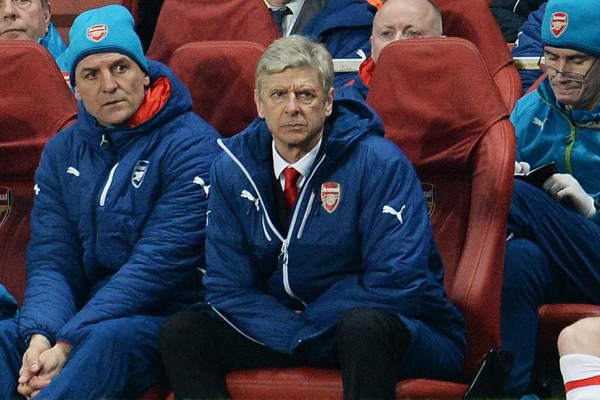 Arsenal manager Arsene Wenger looks on during the club's Champions League match against Monaco, which they lost 3-1, at the Emirates Stadium in London on Feb 25, 2015. Wenger gave a scathing review of his team's poor peformance at the match, calling 