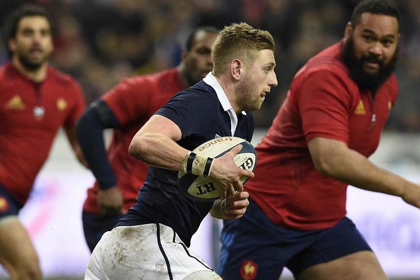 Scotland's fly-half Finn Russell runs with the ball during the Six Nations international rugby union match between France and Scotland, at the Stade de France, northern Paris on Feb 7, 2015. -- PHOTO: AFP