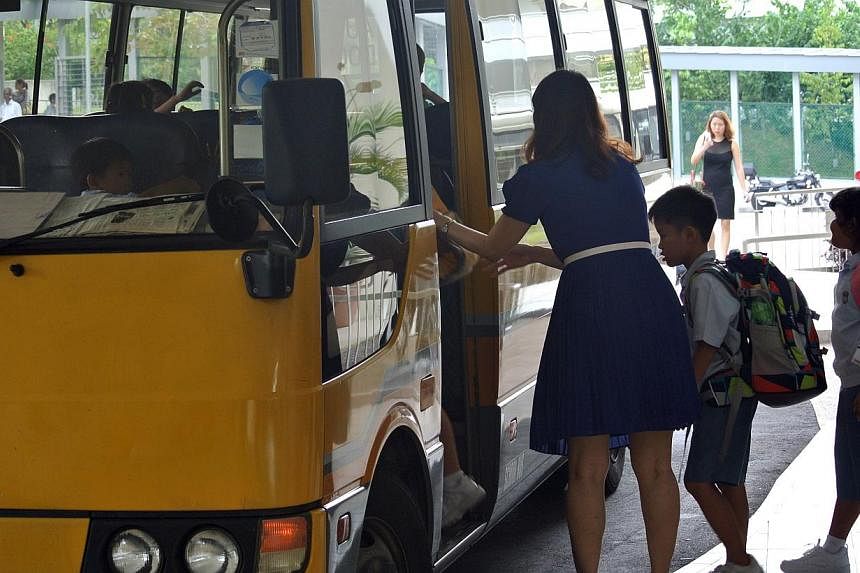 Parents with primary school-going children who receive financial aid from the Government welcomed transport subsidies announced in the Budget on Monday. -- PHOTO: THE NEW PAPER&nbsp;