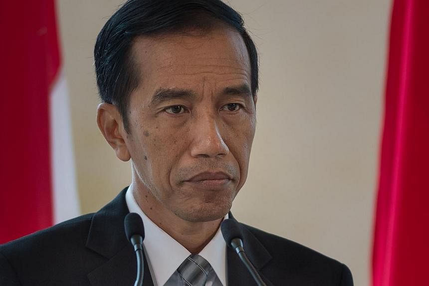 Indonesian President Joko Widodo is "carefully considering his position" on two Australians facing imminent execution for drug trafficking, says Australian Prime Minister Tony Abbott. -- PHOTO: AFP