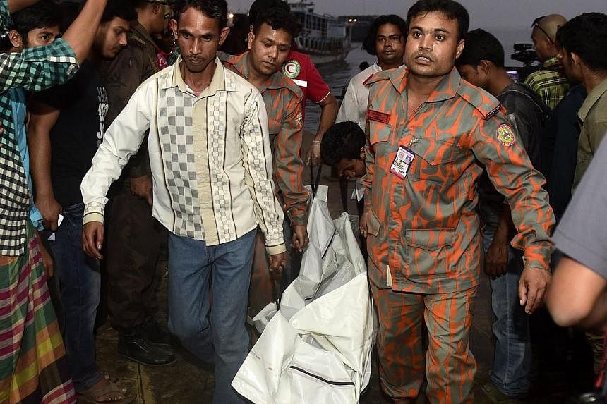 Bangladeshi rescue workers recover the body of a victim after a ferry accident at Paturia some 70kms east of Dhaka on Feb 22, 2015. Nine bodies were retrieved from a river in central Bangladesh on Wednesday, bringing to 79 the number of people known 