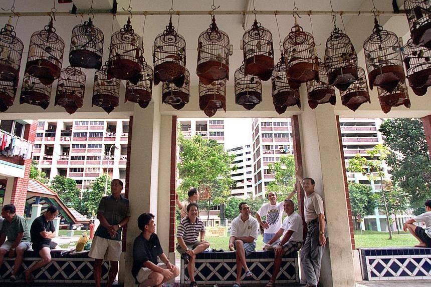 Residents bonding over their shared interest in birds in a void deck in Yishun. A void deck has many social uses, said Mr Chan Chun Sing, and instead of infringing on these spaces, childcare centres can be designed upfront into the second storey or c
