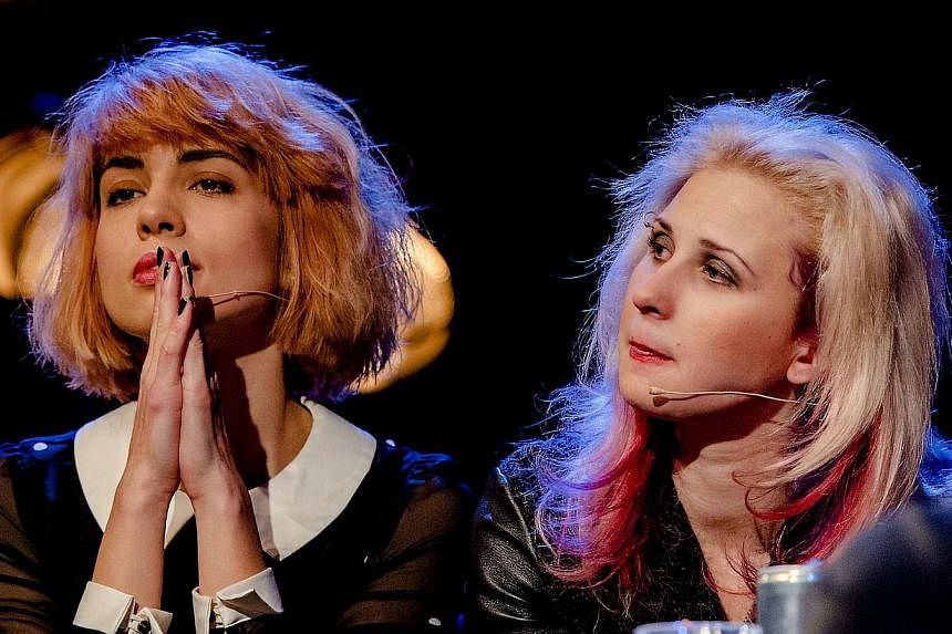The two Pussy Riot punk rockers who served jail time for a stunt slamming President Vladimir Putin -&nbsp;Nadezhda Tolokonnikova (left) and Maria Alyokhina -&nbsp;have once again struck out at the Russian leader. -- PHOTO: AFP