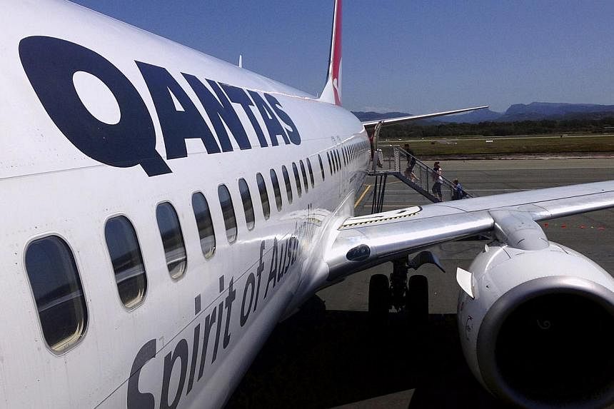 Australian carrier Qantas on Thursday roared back into the black after an aggressive shake-up to stem mounting losses, posting its best interim result in four years. -- PHOTO: REUTERS