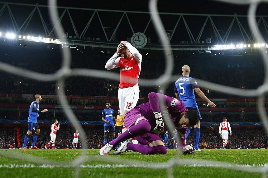 Arsenal striker Olivier Giroud (in red)&nbsp;reacts after missing a chance to score during&nbsp;his match against AS Monaco at the&nbsp;UEFA Champions League in London&nbsp;on Feb 25, 2015. Giroud has vowed to bounce back from his Champions League hu
