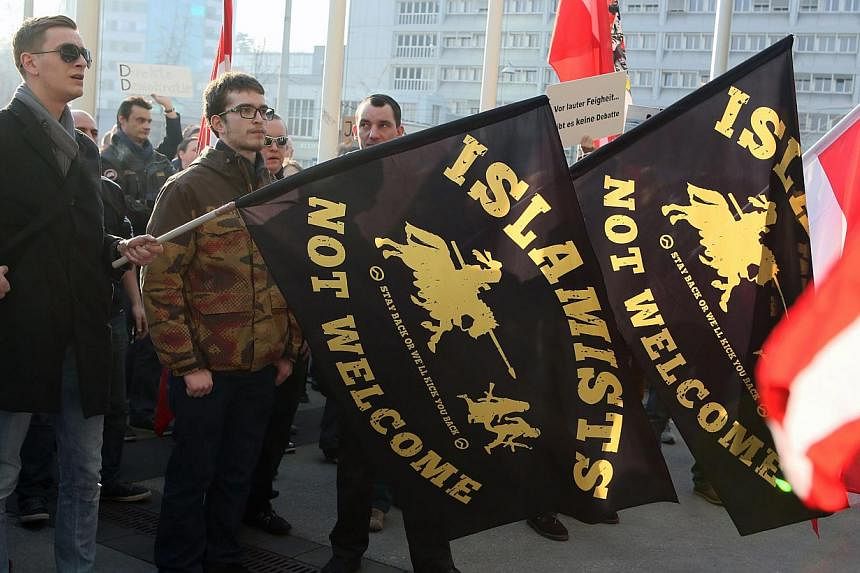Participants hold flags during a rally of Anti-Islam movement Pegida in Linz, Austria on&nbsp;Feb 21, 2015. The German-based Pegida movement, which opposes what it calls the "Islamisation" of Europe, was staging its first demonstration on British soi