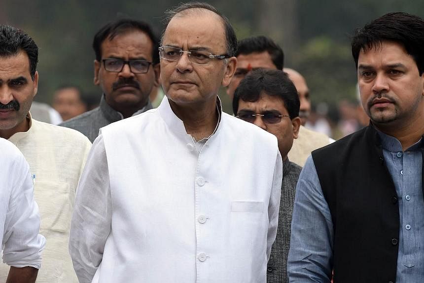 Indian Finance Minister Arun Jaitley walks with party officials and Members of Parliament after a Bharatiya Janata Party (BJP) Parliamentary Board meeting at Parliament House in New Delhi on Feb 24, 2015. -- PHOTO: AFP